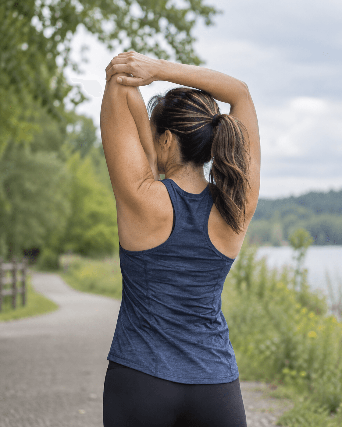 Active adult practicing shoulder mobility outdoors